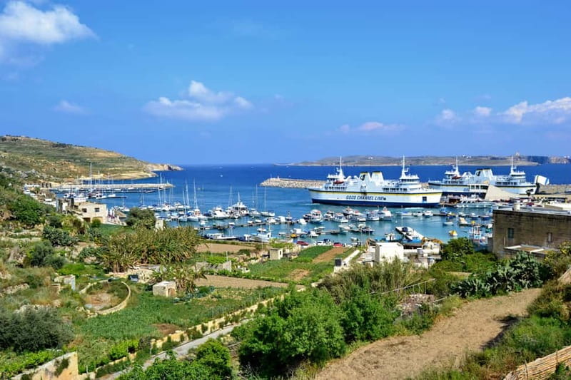 Comino & Gozo: Blue & Crystal Lagoons Cruise with Sea Caves - Gozo Harbour and the rugged coastline photo moment