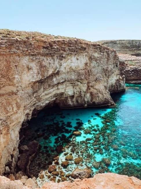 Comino & Gozo: Blue & Crystal Lagoons Cruise with Sea Caves - Getting underway from Ċirkewwa, with Comino Tower in view