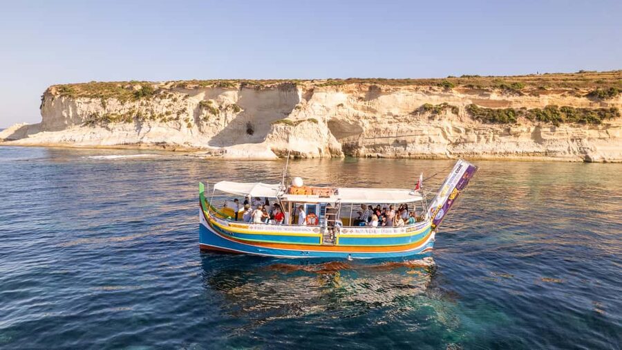 Malta: Sunset Boat Tour to St. Peter’s Pool and South Coast - Historic salt pans and Marsaxlokk Lighthouse on the southeast return