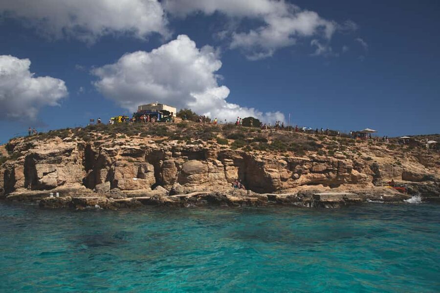 St Pauls: Gozo & Comino, Blue Lagoon & Seacaves Tour - Sea cave views from the boat, plus the Santa Maria Caves photo stop